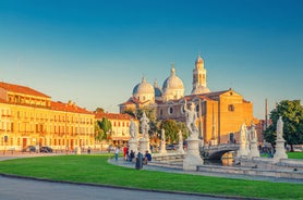 Photo of beautiful view of canal with statues on square Prato della Valle and Basilica Santa Giustina in Padova (Padua), Veneto, Italy.