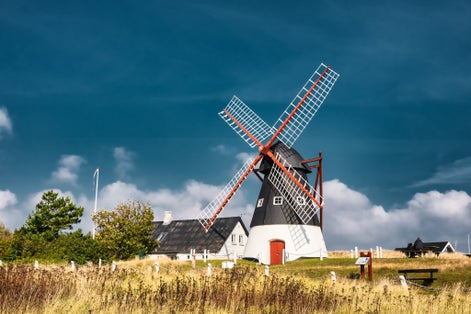 photo of view of Dutch wind mill on the island Mandoe in the wadden sea, Esbjerg, Denmark.