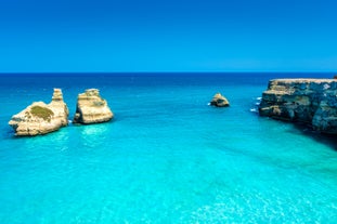 Photo of aerial view of Otranto town in Puglia with crystal turquoise waters, Italy.