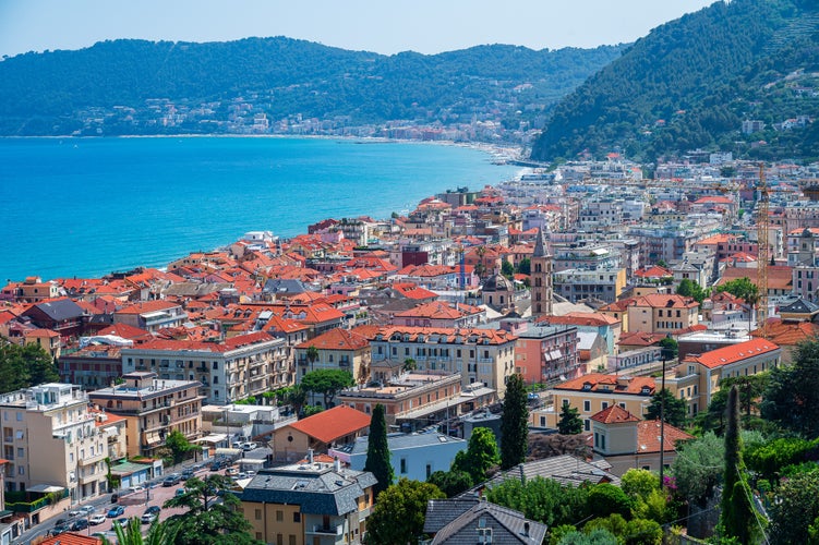 Photo of beautiful view of sea and town of Alassio With colorful buildings during summer day, Italy.