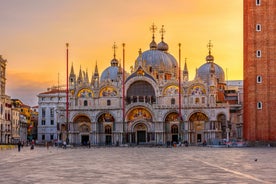 Famous buildings, gondolas and monuments by the Rialto Bridge of Venice on the Grand Canal, Italy.