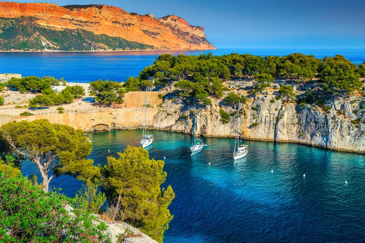 Photo of Fantastic vacation place, stunning viewpoint on the cliffs, Calanques de Port Pin bay with yachts and sailing boats, Calanques National Park near Cassis, Provence, South France, Europe.