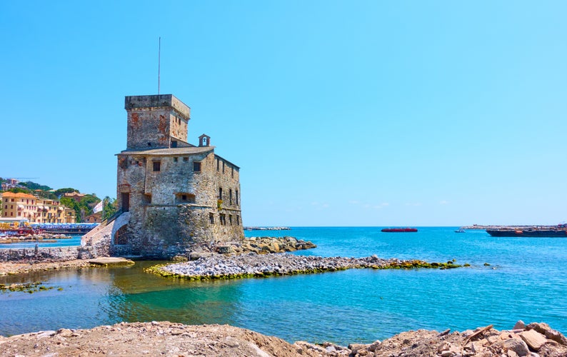 Photo of medieval Rapallo Castle on the sea shore in Rapallo, Genoa, Italy.