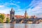 Photo of scenic aerial sunset on the architecture of the Old Town Pier and Charles Bridge over the Vltava River in Prague, Czech.