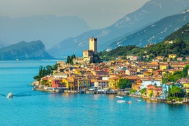 Photo of aerial view of superb Malcesine Mediterranean cityscape with colorful buildings and boats, yachts in the bay, lake Garda, Italy.