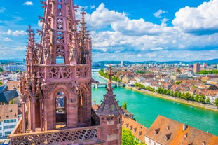 Geneva skyline cityscape, French-Swiss in Switzerland. Aerial view of Jet d'eau fountain, Lake Leman, bay and harbor from the bell tower of Saint-Pierre Cathedral. Sunny day blue sky.