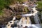 photo of waterfall during autumn in Danska Fall in Simlångsdalen, Sweden.