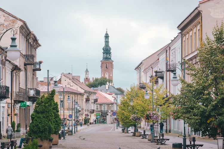 Photo of Pedestrian street in the city center with Church tower of St. Jacob in the background in Radom, Poland.