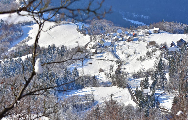 On the photo is winter landscape from Slovenia. With tipicaly village on the hill. View from Tolsti vrh, Celje.