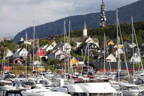 photo of view of Yachts, boats and hillside living in Norwegian harbour town Sandnessjøen.