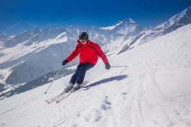 photo of beautiful snow capped mountains with Arosa village in France. Back country skier in the foreground leave their tracks in the deep snow.