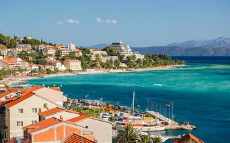 Photo of panorama and landscape of Makarska resort and its harbour with boats and blue sea water, Croatia.