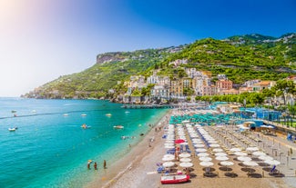 Naples, Italy. View of the Gulf of Naples from the Posillipo hill with Mount Vesuvius far in the background and some pine trees in foreground.