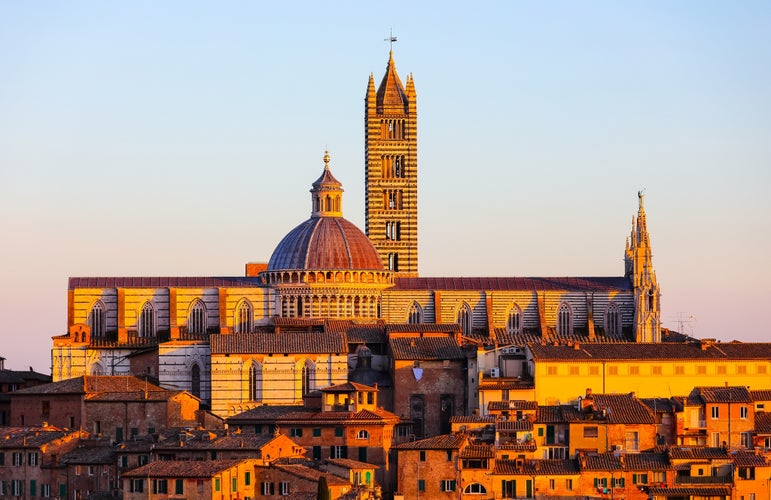 photo of view of Cathedral of the City of Siena in Tuscany region of Italy at sunset.