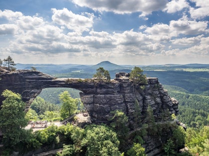 Photo of Pravčická brána natural rocky arc gate of Bohemian Switzerland (České Švýcarsko) national park in day time. Bohemian Switzerland, Czech Republic.