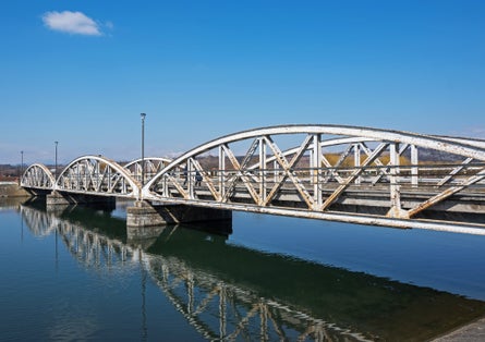 Steel bridge over the water, over Jiu. Ferdinand Bridge in Targu Jiu.
