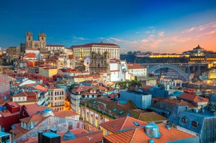 Porto, Portugal old town ribeira aerial promenade view with colorful houses, Douro river and boats.