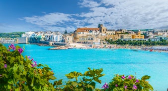 Photo of aerial view of Otranto town in Puglia with crystal turquoise waters, Italy.