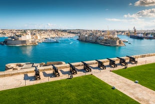 Photo of Msida Marina boat and church reflection into water, Malta.