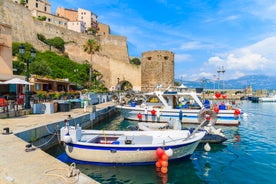 Photo of aerial view from the walls of the citadel of Calvi on the old town with historic buildings and bay with yachts and boats, Corsica, France.