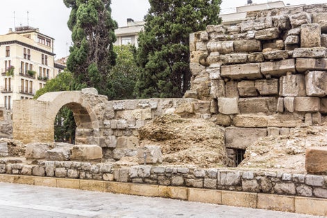 Photo of Roman Walls in downtown: Avenida Cesar Augusto (2nd - 3rd centuries A.D.). There is a fortified tower followed by walls. These were used to defend the city during the Middle Ages. Zaragoza, Spain.