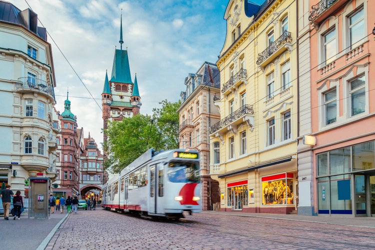 photo of Historic town of Freiburg im Breisgau with tram and famous medieval Martinstor (Martin's Gate) town gate in beautiful day in summer, state of Baden-Wurttemberg, Germany.