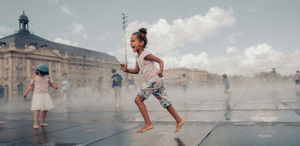 Children playing in the mist at Miroir d’Eau (Water Mirror) in front of Bourse Square in Bordeaux..jpg