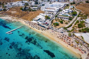 Photo of panoramic aerial view of the popular Platis Gialos beach on the Greek island of Mykonos with turquoise sea, Greece.