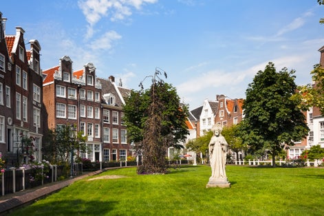 photo of famous historic Begijnhof (Beguinage, 1346) is one of the oldest inner courts in the city of Amsterdam. Begijnhof was founded during the middle Ages. Amsterdam, Netherlands.