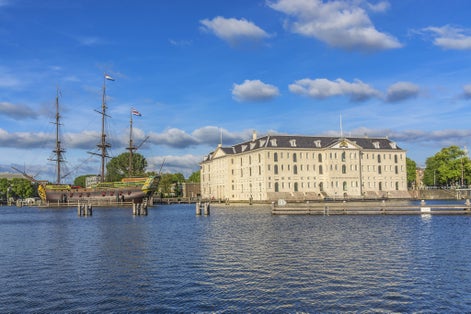 photo of a replica (1985) of ship Amsterdam was moored next to Netherlands Maritime Museum in Amsterdam, Netherlands. VOC ship Amsterdam was an 18th century cargo ship of Dutch East India company.