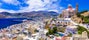 Photo of aerial view of beautiful Syros island panoramic view with church and port, Ermoupoli, Greece.