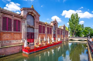 Photo of traditional half-timbered houses on picturesque canals in La Petite France in the medieval fairytale town of Strasbourg, France.