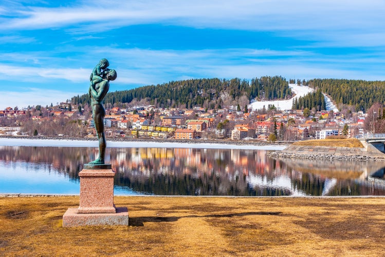 Skyline of Ostersund with a statue of father and a kid in Sweden.