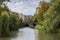 Photo of river Leam flowing through Jephson Gardens, on a beautiful Autumn day, golden tree leaves Royal Leamington Spa, England, UK.