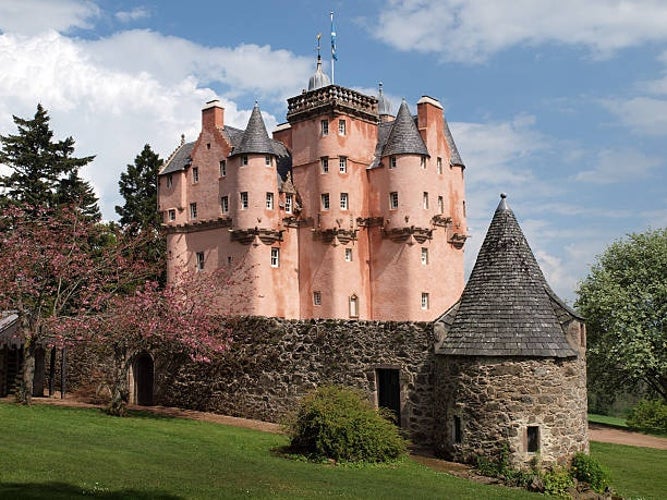 Craigievar Castle, a striking pink-hued tower house showcasing its fairytale-like architecture in the Scottish countryside..jpg