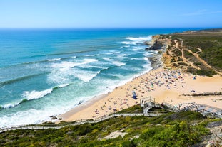 Photo of aerial view of Costa da Caparica coastline of glorious sandy beaches, powerful Atlantic waves, Portugal.