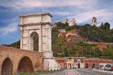 Ancona, Marche, Italy: the ancient Roman triumphal arch of Trajan built in the 2nd century AD in the port of the city and on background the medieval catherdral