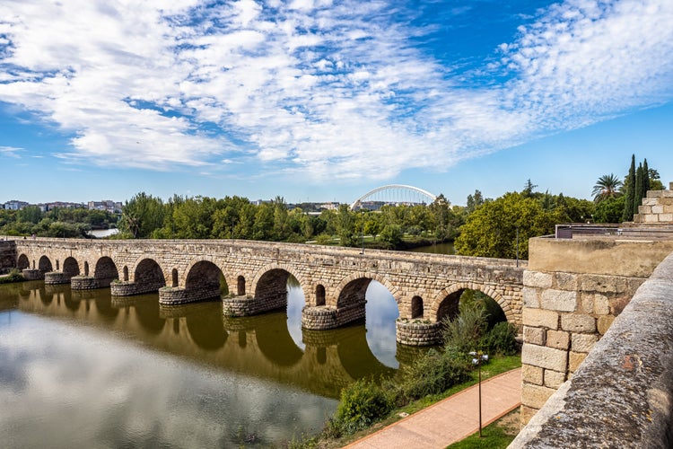 photo of view of Historical Bridge, built by the Romans. It is the longest surviving Roman bridge, over the Guadiana River in Merida, Extremadura, Spain. Puente Romano is the Spanish name for the Roman Bridge.