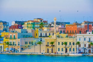 Photo of panoramic view of the ancient town of Matera (Sassi di Matera), European Capital of Culture 2019, in beautiful golden morning light with blue sky and clouds, Basilicata, southern Italy.