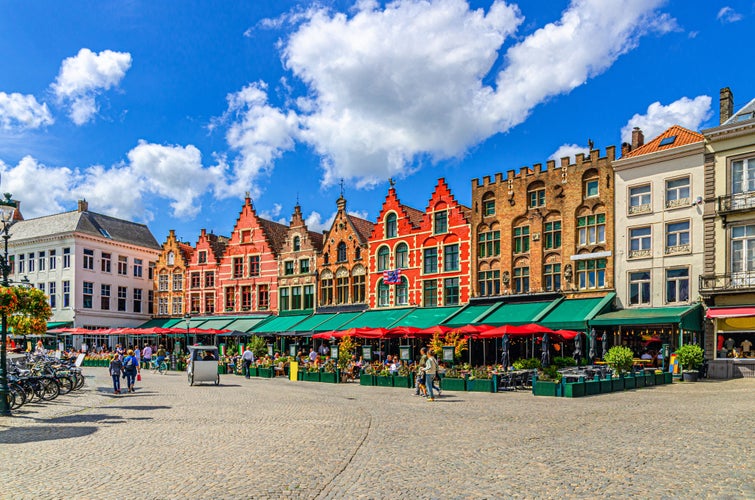 Traditional Flemish-Baroque-style townhouses buildings with colourful facades and street restaurants on Market square in Brugge old town, Bruges city historical centre, Flemish Region, Belgium.jpg