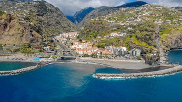 Photo of panoramic aerial view of idyllic coastal village of Porto da Cruz Madeira island, Portugal.