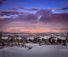 photo of beautiful vibrant aerial winter mountain view of ski resort Trysil, Norway. sunny winter day with slope, piste and ski lift.