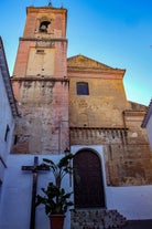 photo of Almuñécar, Spain - A scenic view of a coastal city with white buildings and a blue ocean in the background.