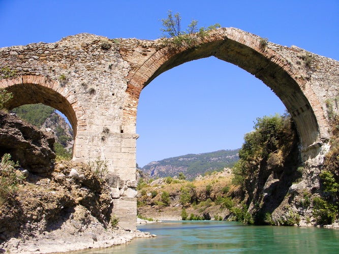 Photo of panorama view to old ruined bridge over Dalaman river in Turkey.