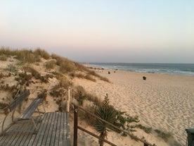 Photo of aerial view of Costa da Caparica coastline of glorious sandy beaches, powerful Atlantic waves, Portugal.