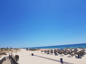 Photo of aerial view of pier fishing boats in the village Cabanas de Tavira, Portugal.