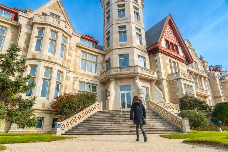 photo of view  of A woman walking in the Magdalena Palace in the city of Santander, Spain