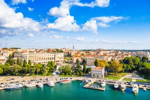 photo of an aerial view of the stunning Croatian coastal town of Pomer, with its picturesque oceanfront buildings and harbor.