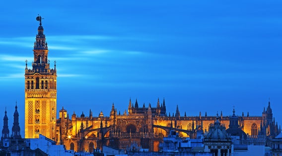 Photo of Stock Photo ID: 645990985  Stunning view of Giralda and Cathedral of Seville illuminated at blue hour .