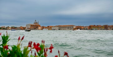 Famous buildings, gondolas and monuments by the Rialto Bridge of Venice on the Grand Canal, Italy.